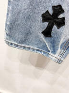 Light blue Chrome pants with a black cross patch near the leg hem