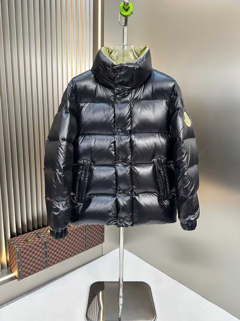 Long puffer jacket with black quilted body and lime green hood