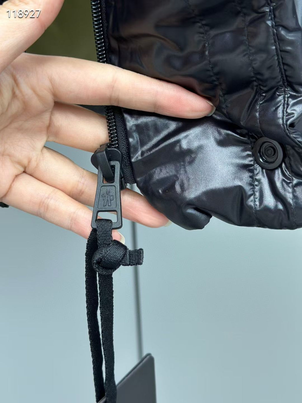 Long puffer jacket with adjustable black strap and snap button detail