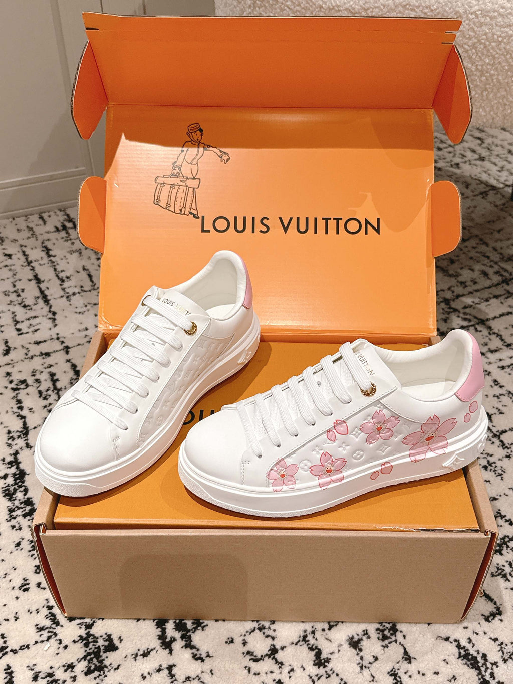 Louis Vuitton white sneakers with pink floral print on side and white lace-up design