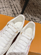 Louis Vuitton white sneakers with lace-up closure and pink floral accents on the side