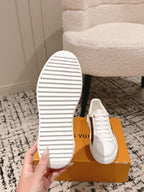 Louis Vuitton white low-top sneakers, striped outsole view