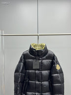 Black long puffer jacket with standing collar and logo patch at chest