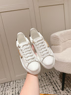 White lace-up low-top sneakers with smooth leather upper and white laces