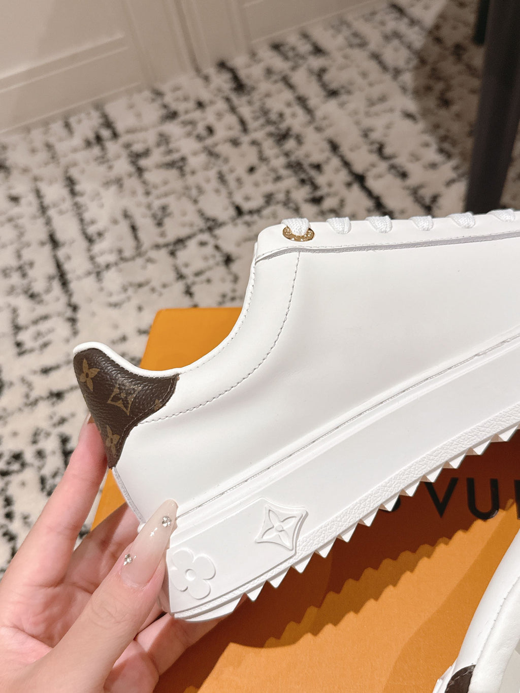 White lace-up sneaker with dark-brown monogram heel and embossed sole pattern