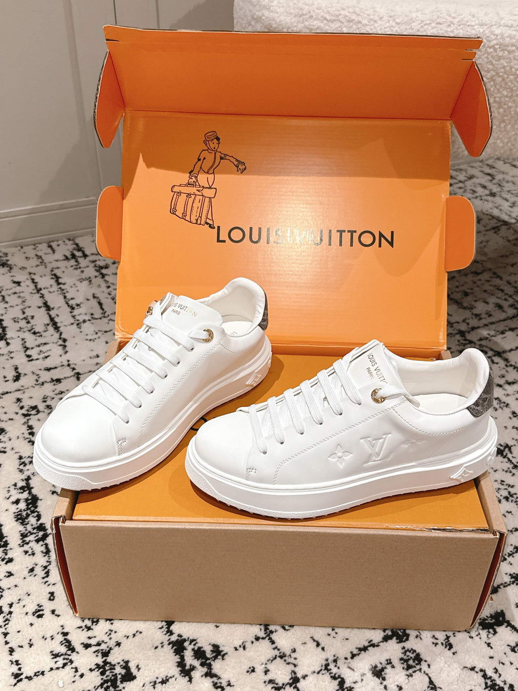 White lace-up low-top sneakers with embossed monogram and chunky rubber sole