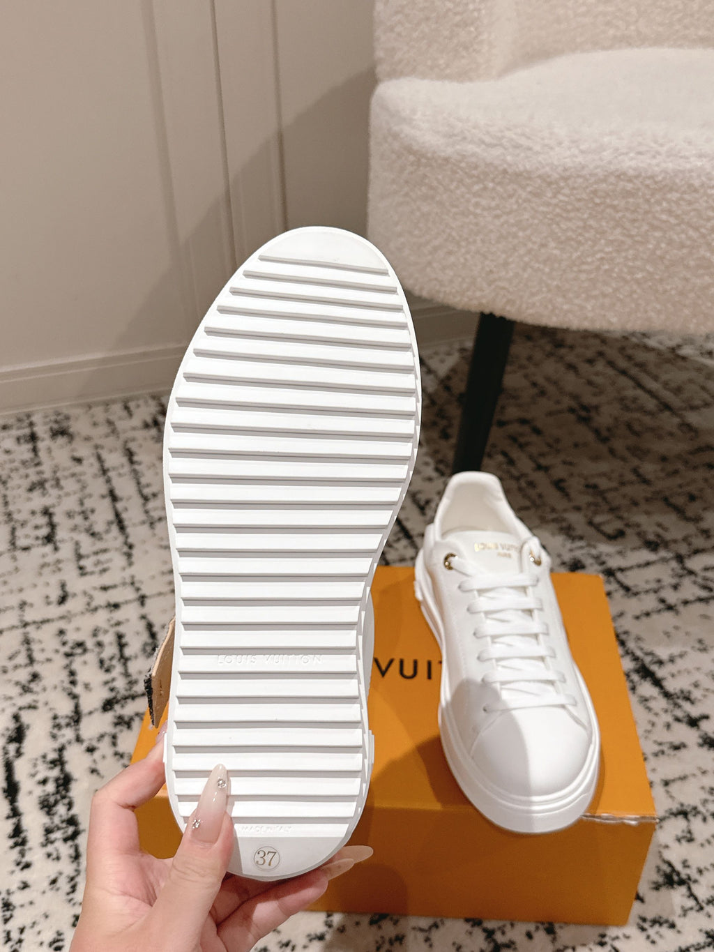 White sneakers outsole view with striped tread and lace-up upper