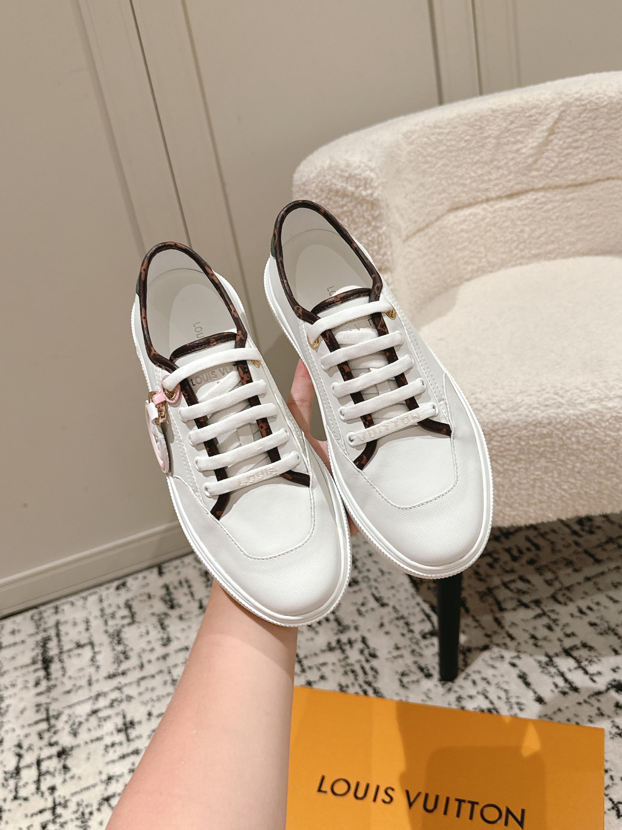 White Louis Vuitton sneakers with white laces and dark trim, side view