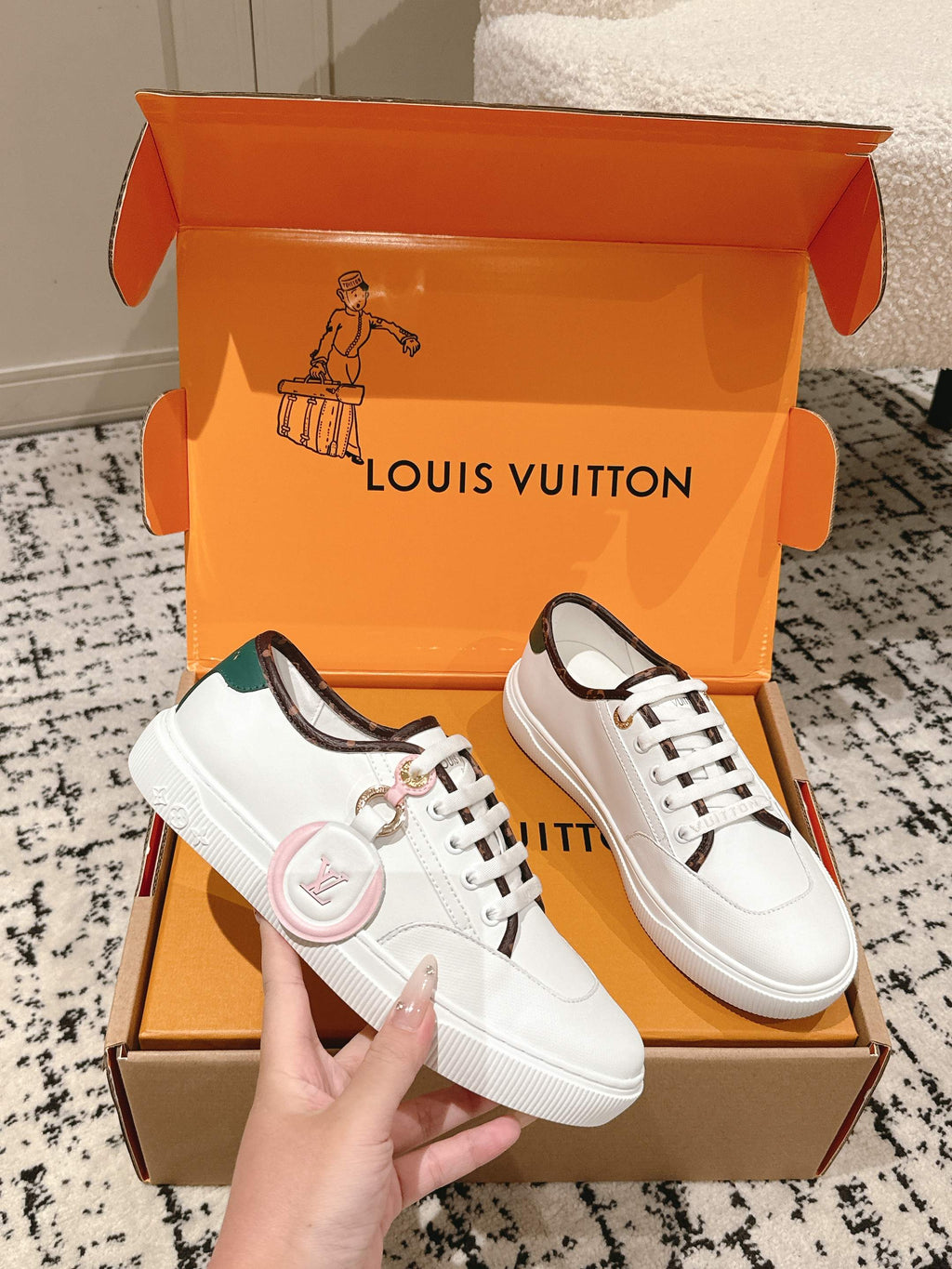 White leather lace-up sneakers with green collar lining and gold eyelets