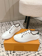 Pair of white leather low-top sneakers with green-and-brown collar trim