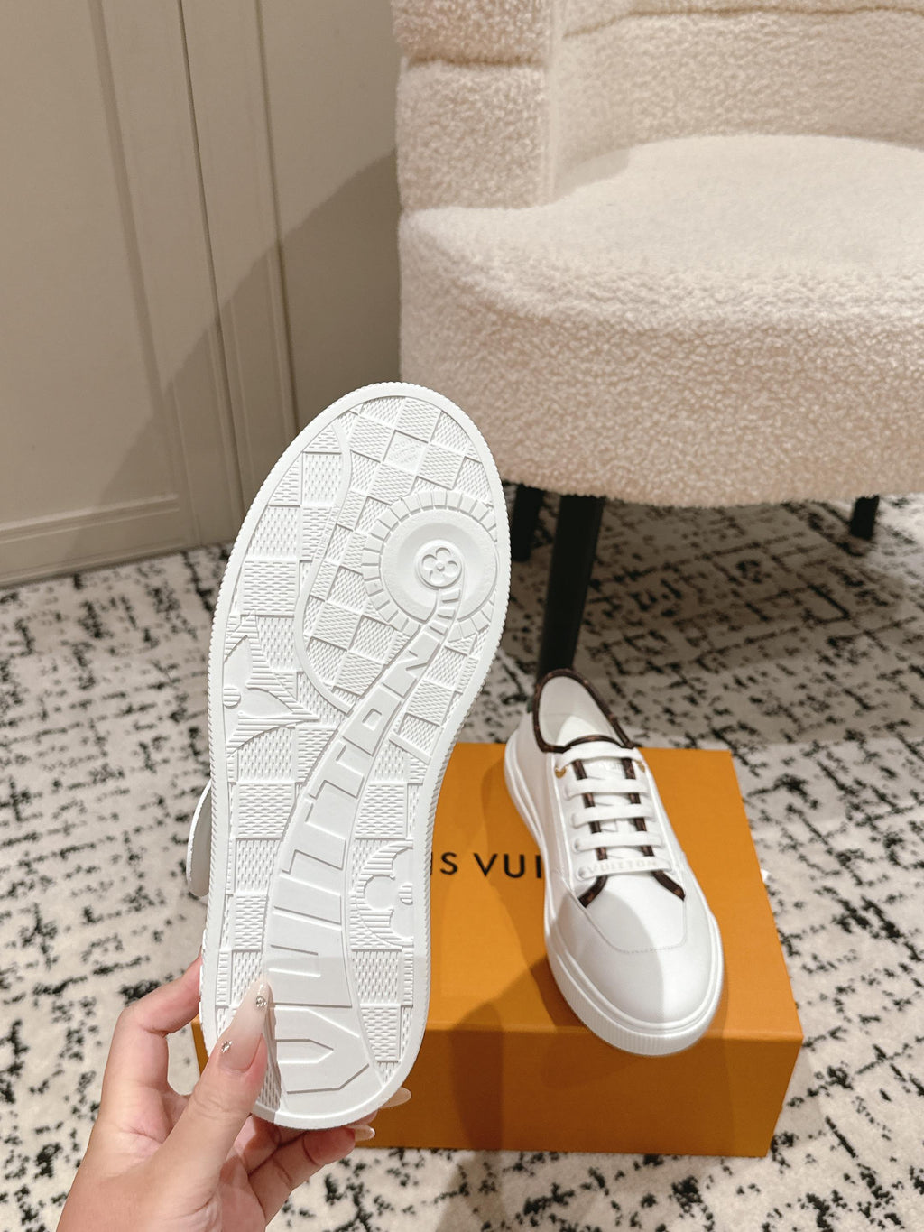 White Louis Vuitton sneakers with outsole tread detail, shown on box
