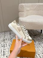 Single Louis Vuitton low-top sneaker in light beige with white laces and stitched side