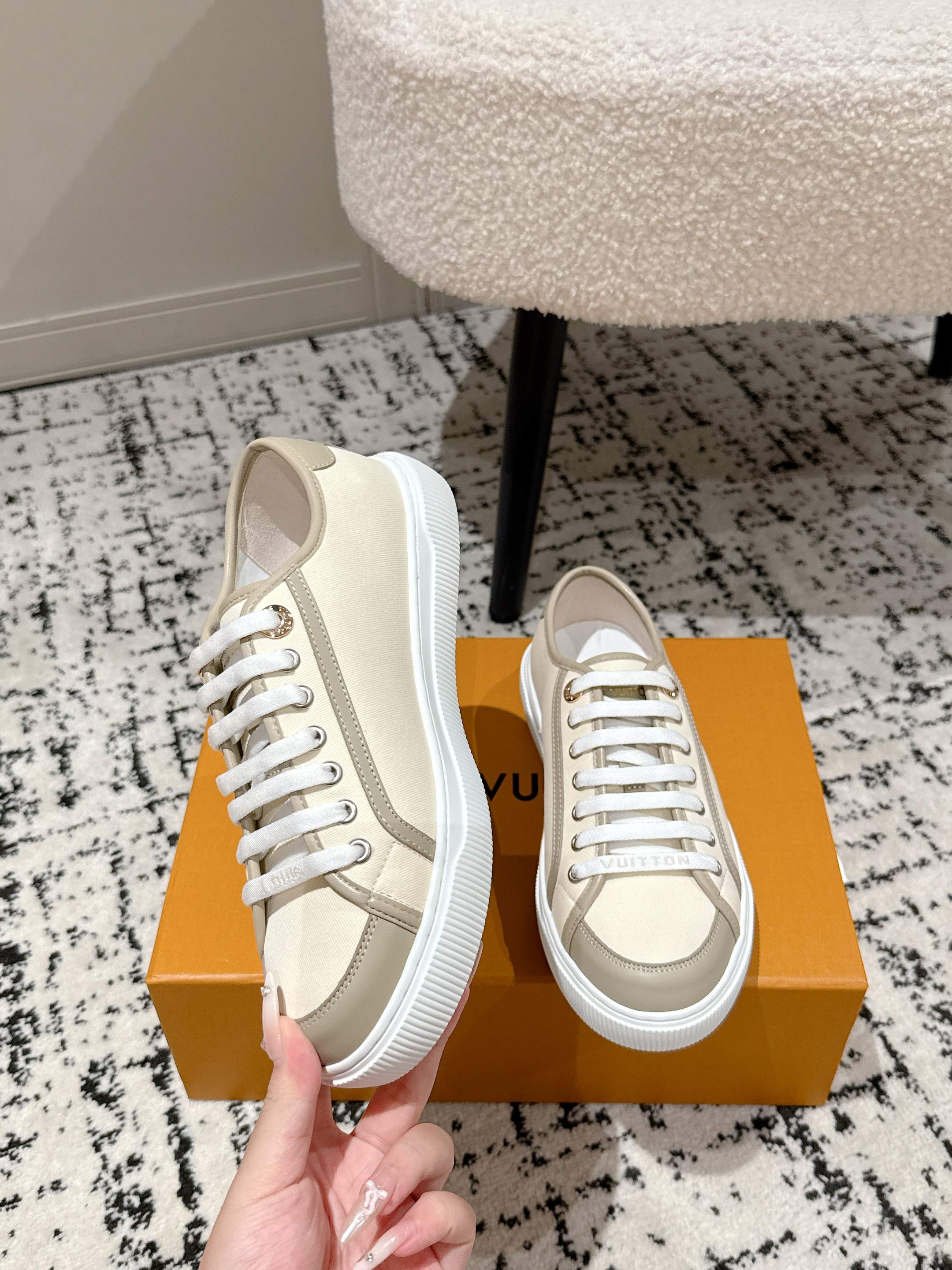 Louis Vuitton low-top sneakers, light beige upper with white laces and textured sole