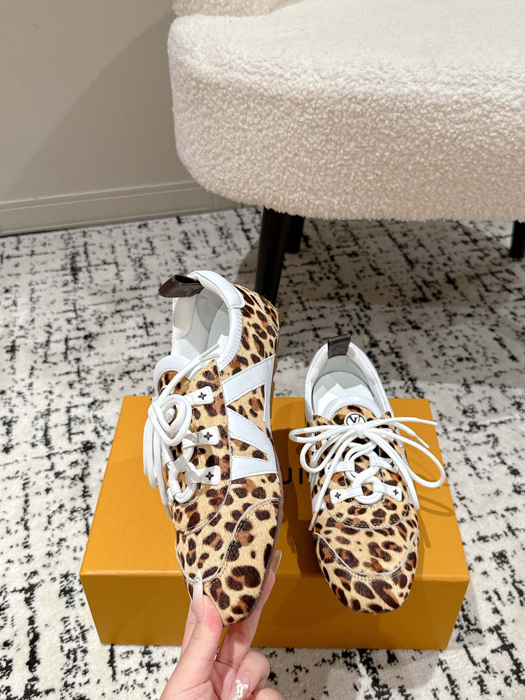 Leopard-print low-top sneaker with white laces and white logo tongue patch