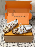 Pair of leopard-print low-top sneakers with white laces and white logo tongue patch
