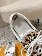 Leopard-print sneaker with white laces, inner lining, and logo emblem on side