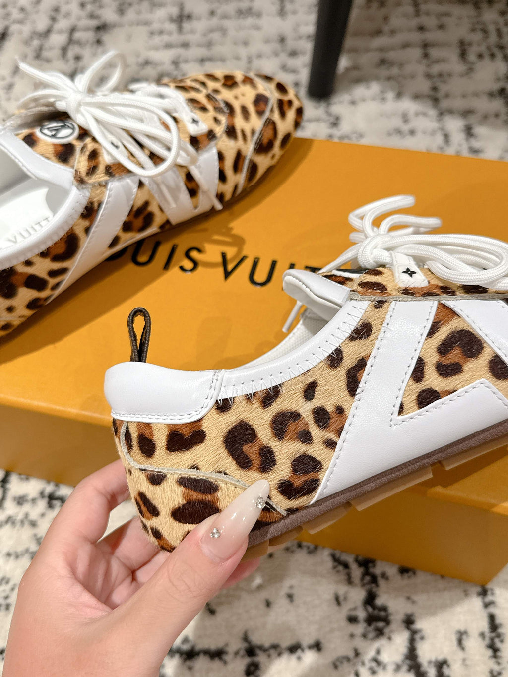 Leopard-print low-top sneaker with white laces and white side panel stripe