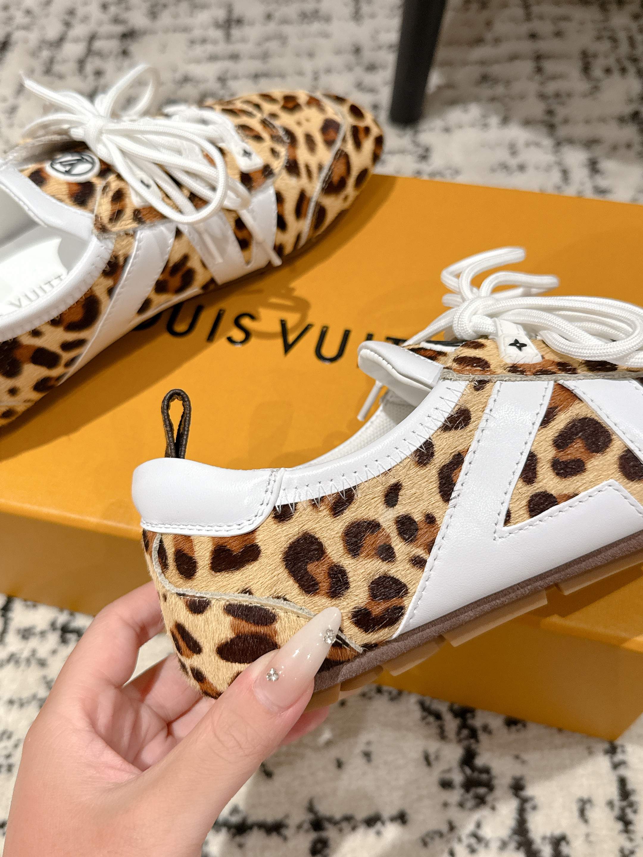 Leopard-print low-top sneaker with white laces and white side panel stripe
