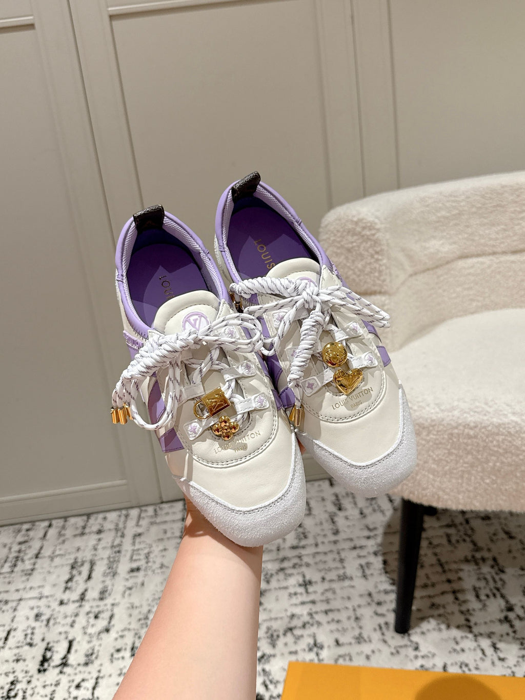 Louis Vuitton lace-up sneakers in white with lavender trim and gold emblem details