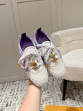 Louis Vuitton lace-up sneakers in white with lavender trim and gold emblem details