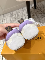 Pair of Louis Vuitton sneakers with white fuzzy suede, lavender strap, and gold heel hardware
