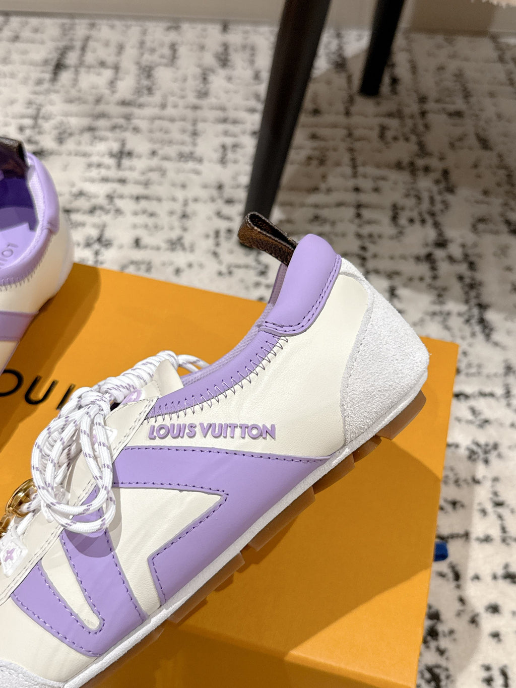 Louis Vuitton low-top sneakers, white with lavender trim and embroidered brand text on side