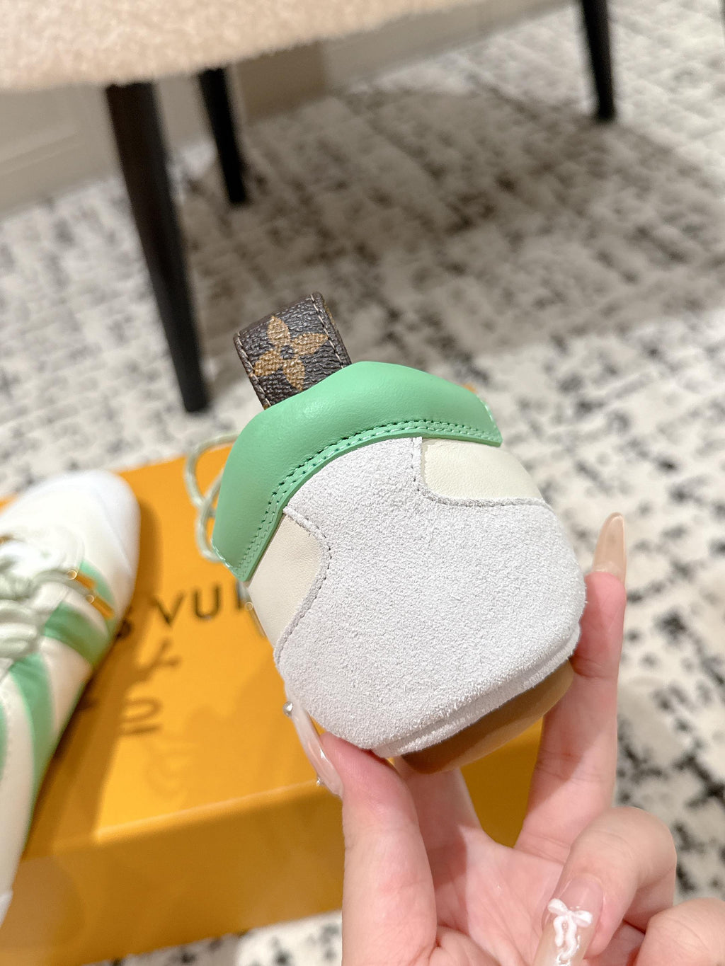 Back view of white sneakers with mint heel trim and lace-up closure