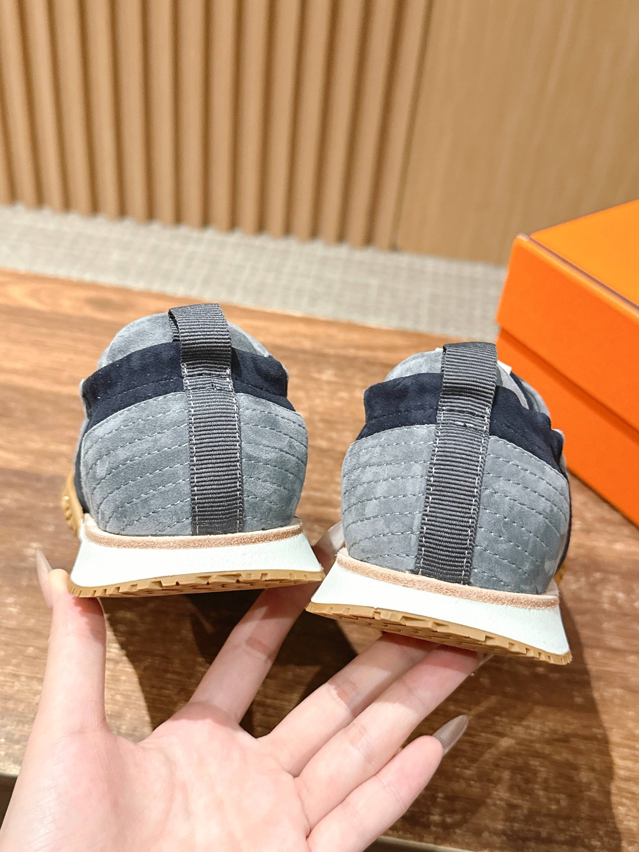 Hermes unisex sneakers back view, navy and light blue suede with elastic heel pull tabs