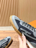 Hermes unisex sneaker close-up, navy and light blue suede with lace-up panel and sole