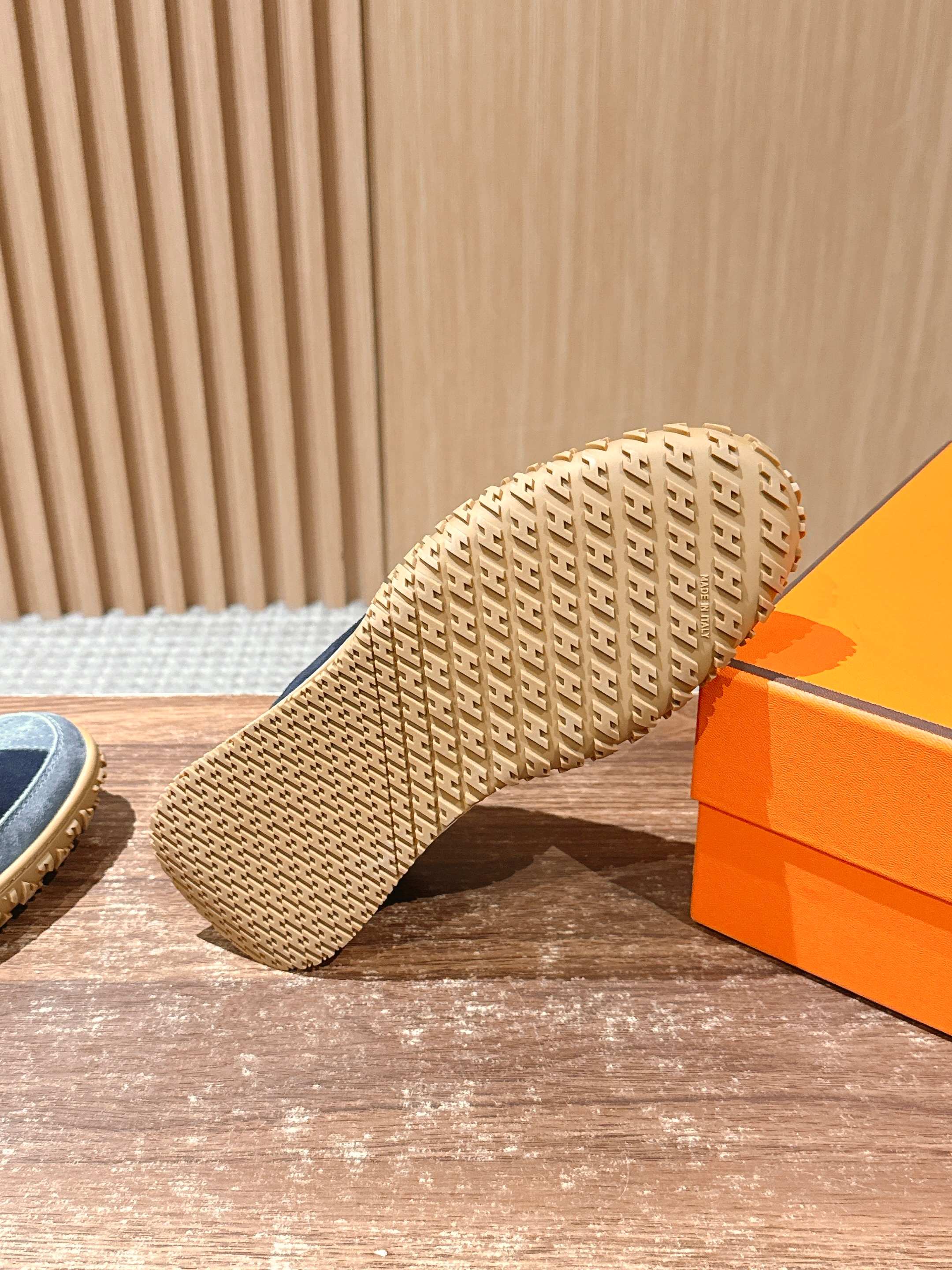 Hermes unisex sneaker outsole view with woven tread sole in light tan color