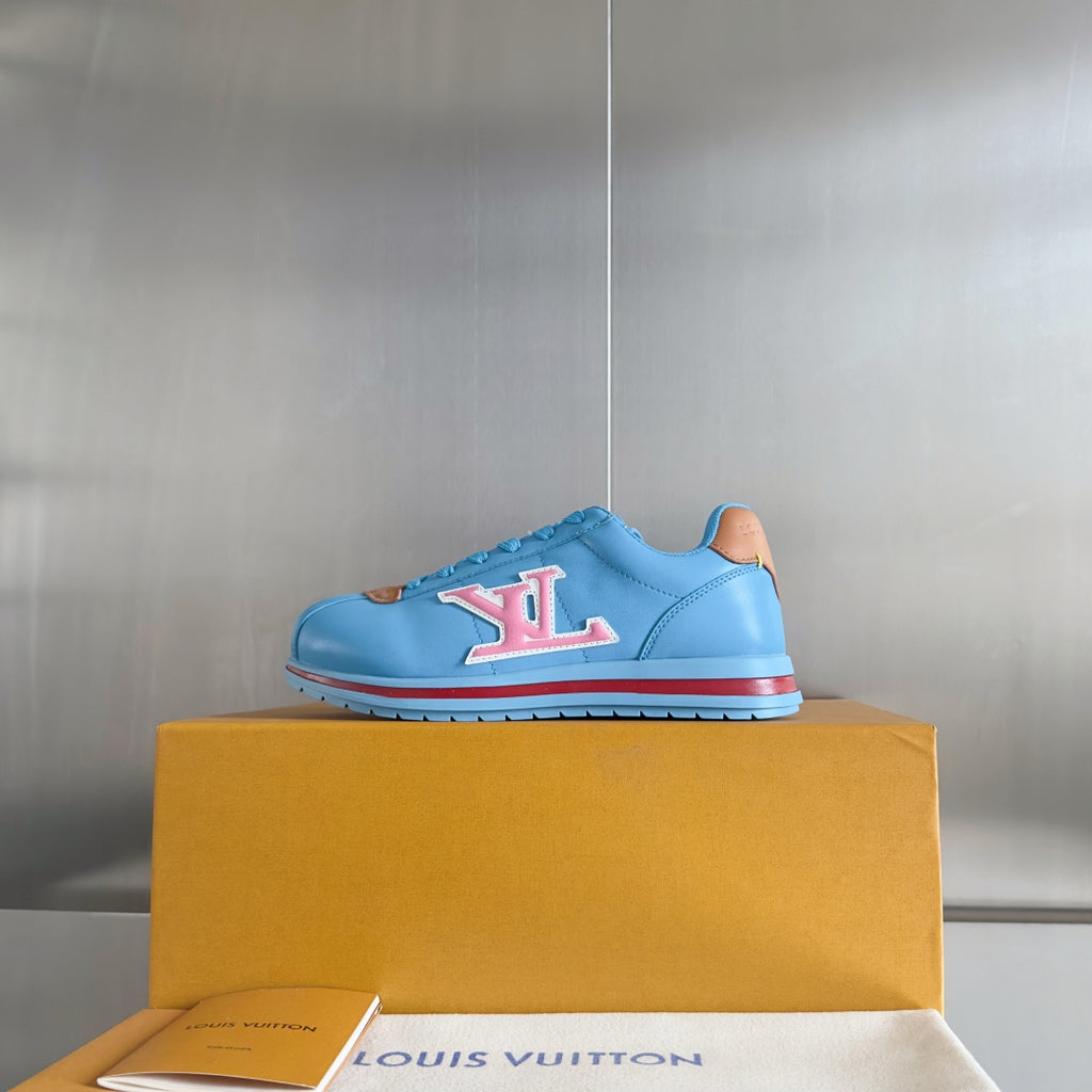 Light blue Louis Vuitton unisex sneakers with LV logo on side and red-trimmed sole