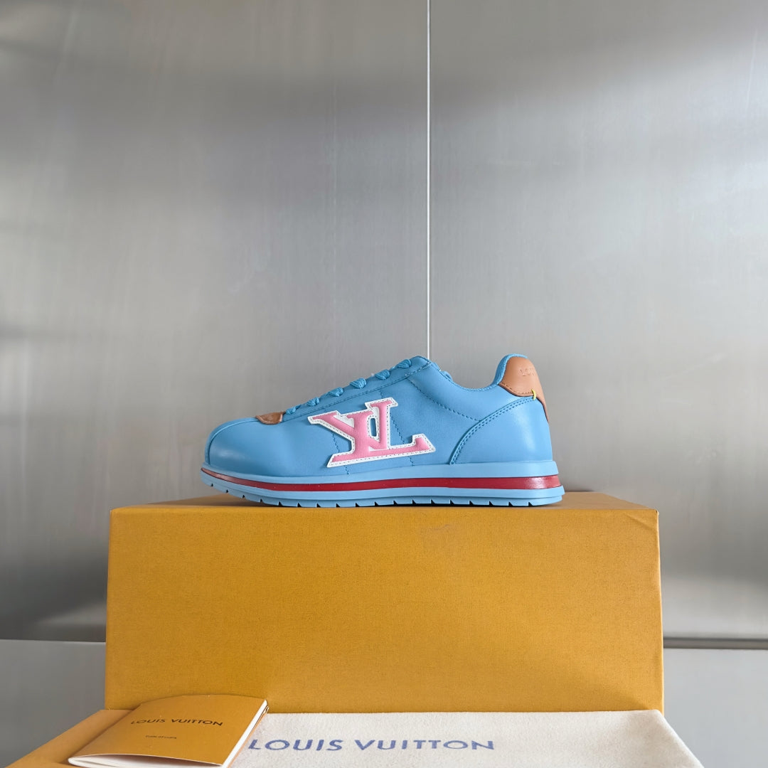 Light blue Louis Vuitton unisex sneakers with LV logo on side and red-trimmed sole