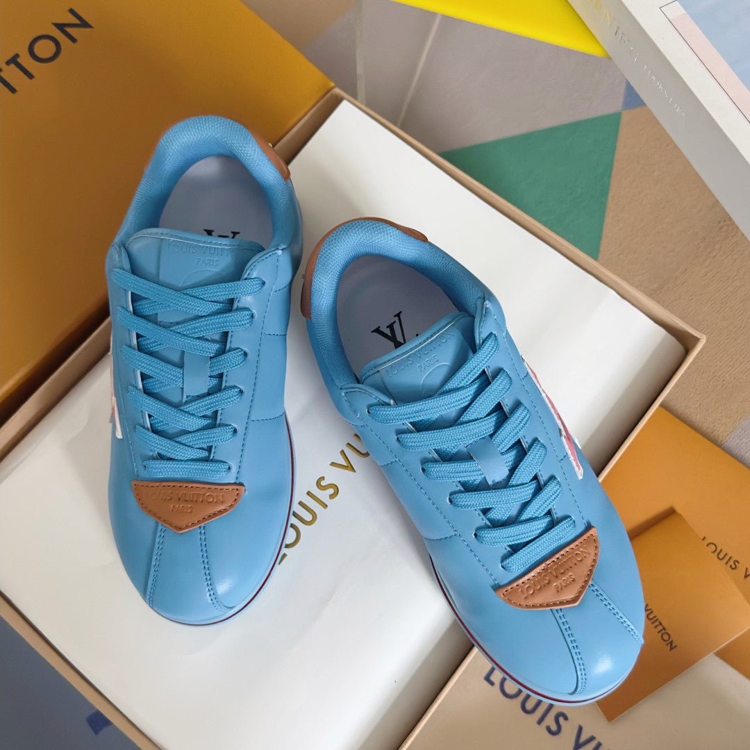 Light blue Louis Vuitton unisex sneakers with lace-up front and brown leather heel details