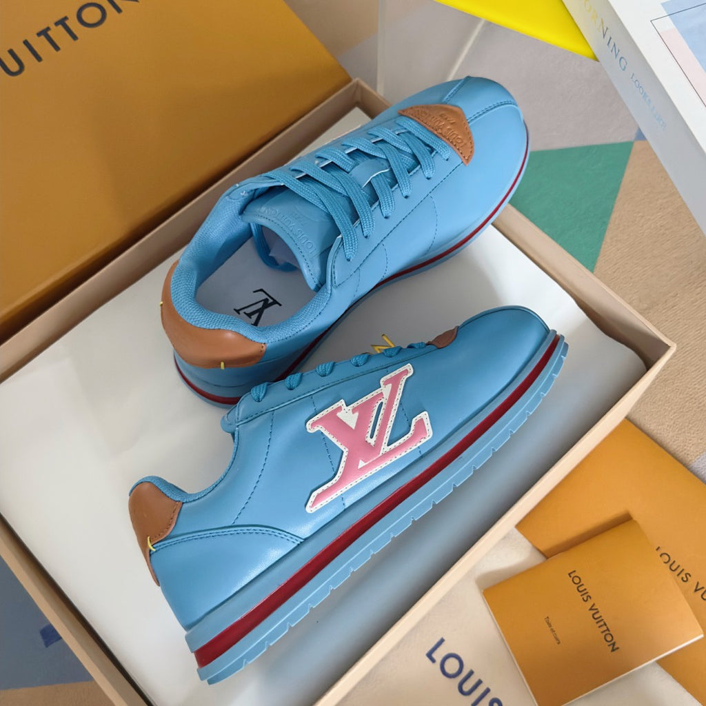 Light blue Louis Vuitton unisex sneakers with colorful LV emblem and red/blue stripe sole