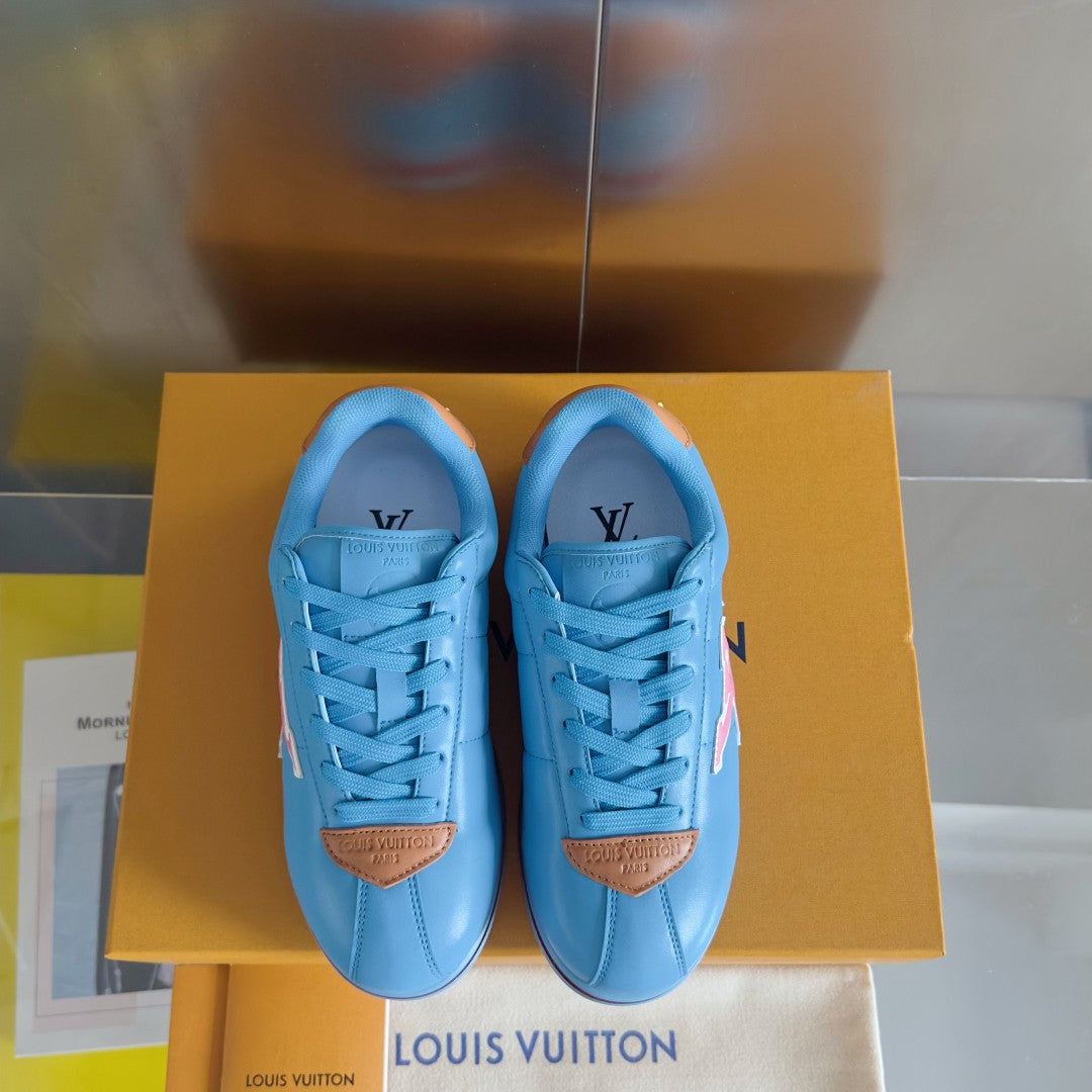 Light blue Louis Vuitton unisex sneakers with lace-up front and brown heel tabs