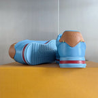 Light blue Louis Vuitton unisex sneakers with rear branding and striped rubber outsole