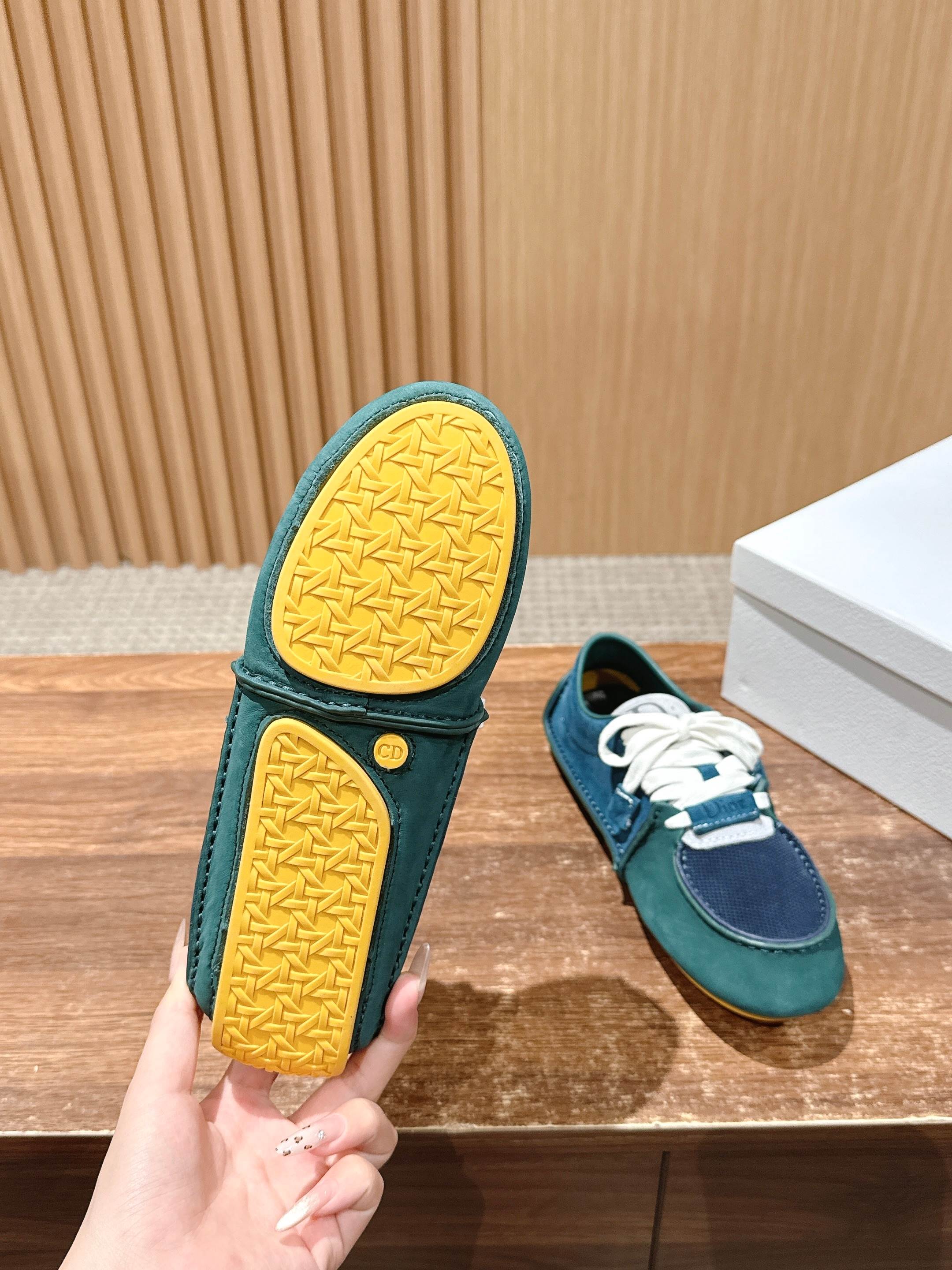 Teal low-top sneaker showing textured yellow outsole, matching navy upper and laces