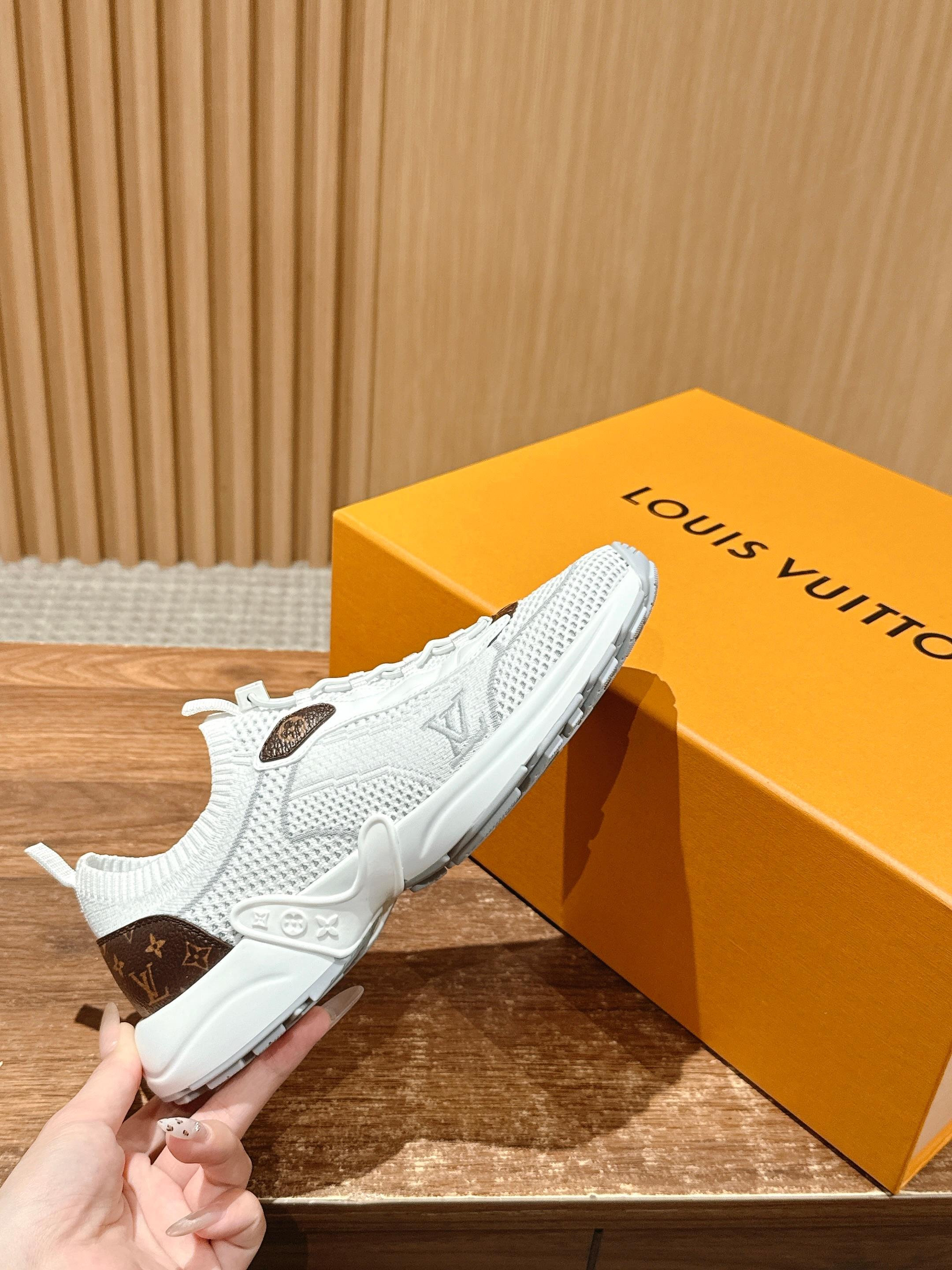 Louis Vuitton unisex white sneakers held in hand; mesh upper with brown monogram patch