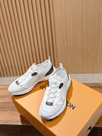 Louis Vuitton unisex white sneakers on orange box; lace-up uppers with brown logo patches