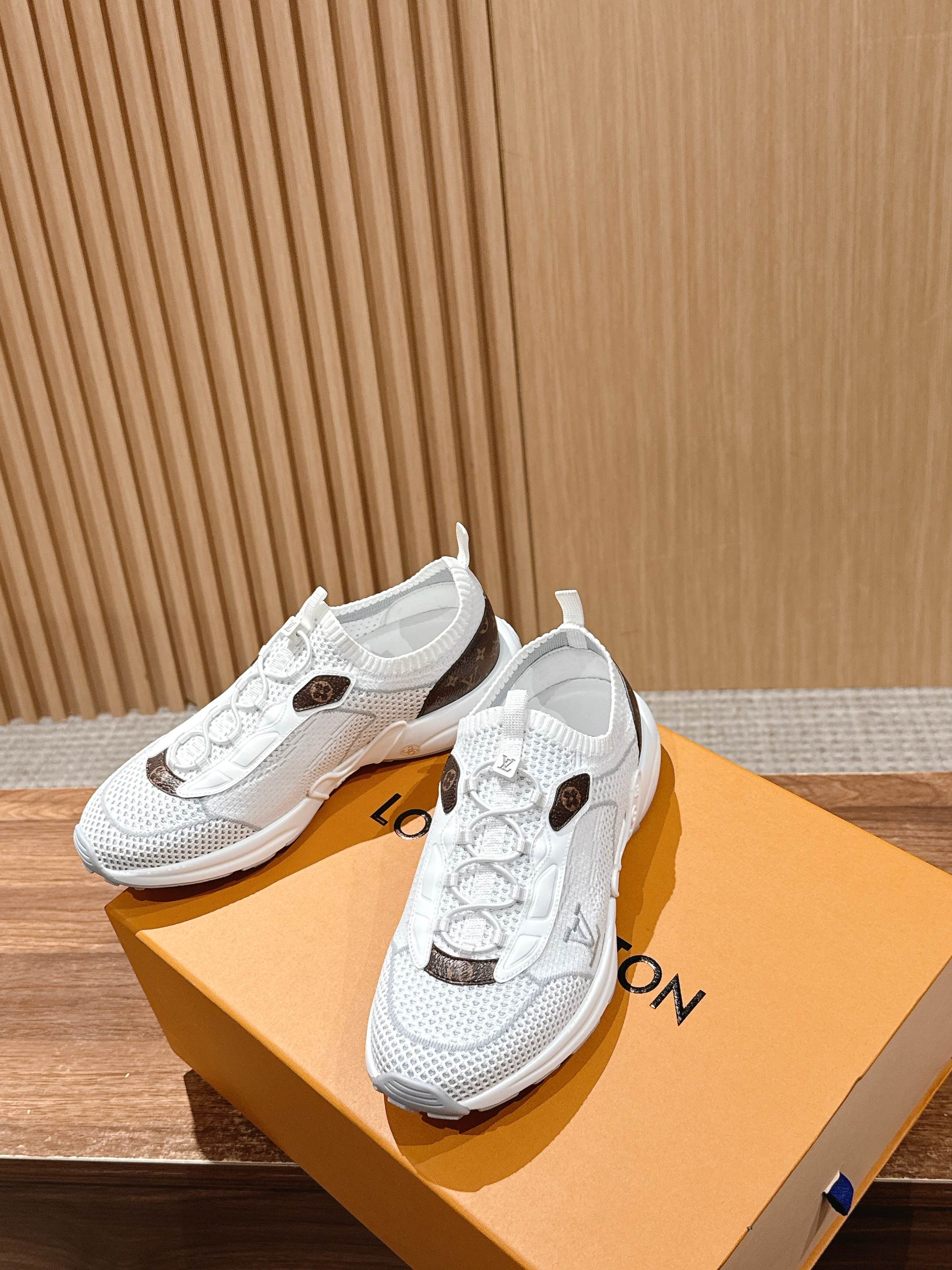 Louis Vuitton unisex white sneakers on orange box; lace-up uppers with brown logo patches