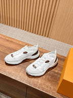 Louis Vuitton unisex white sneakers, side view with brown logo patches and textured sole