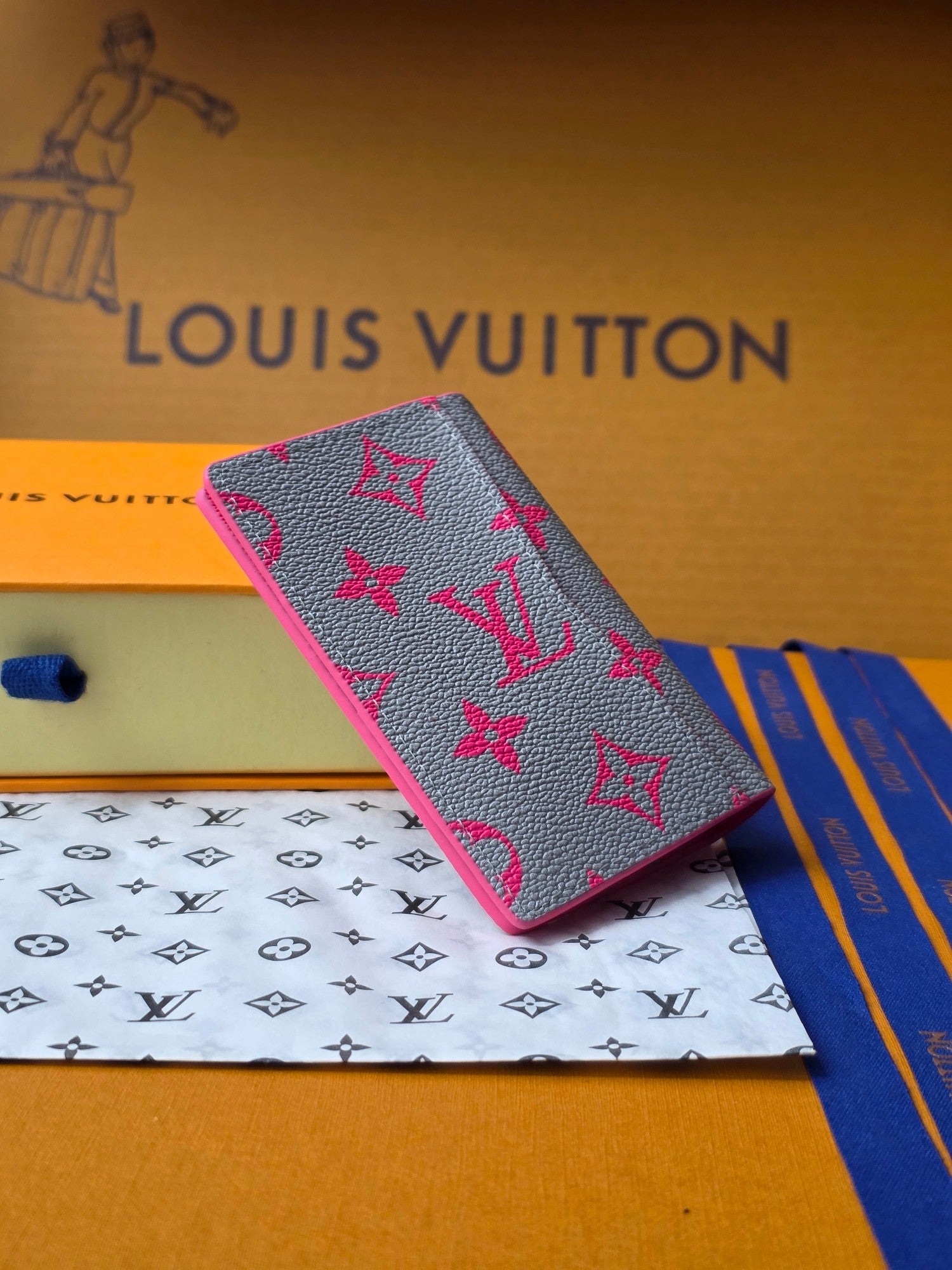Small pink patterned card holder with fold-over flap, shown at an angle