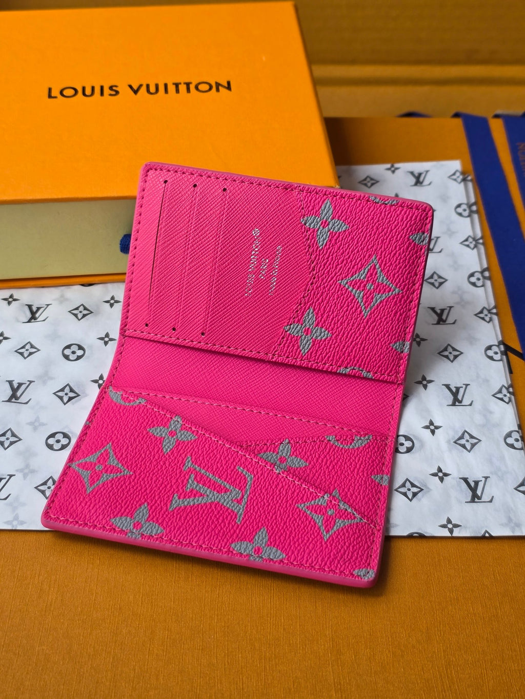 Small pink patterned card holder with fold-over flap and stitched edge detail
