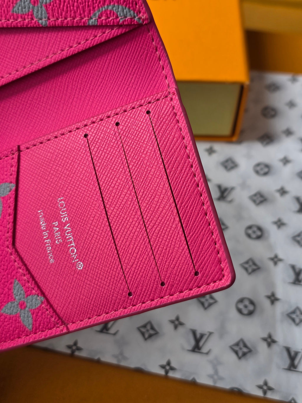 Small pink card holder back close-up with Louis Vuitton Paris stamp and slot panel
