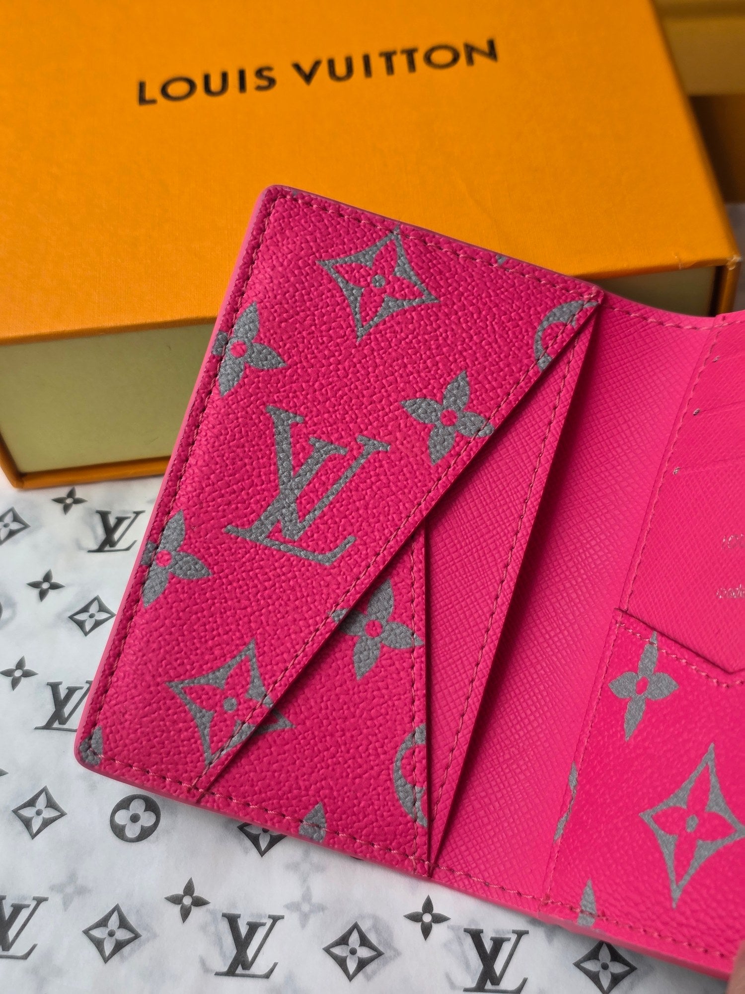 Small pink patterned card holder with multiple card slots and fold-over flap