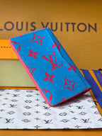 Small bag in bright blue with red monogram-style pattern, close-up