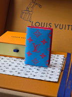 Small bag in bright blue with red monogram-style pattern and textured exterior