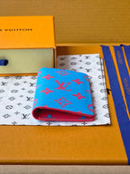 Small bag in blue with red monogram-style pattern, showing open top