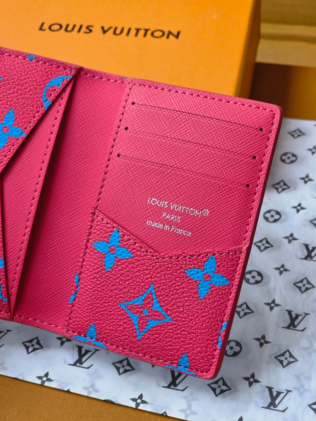 Small bag interior in pink with card slots and printed brand text