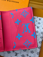 Small bag in pink with blue monogram-style pattern, close-up exterior